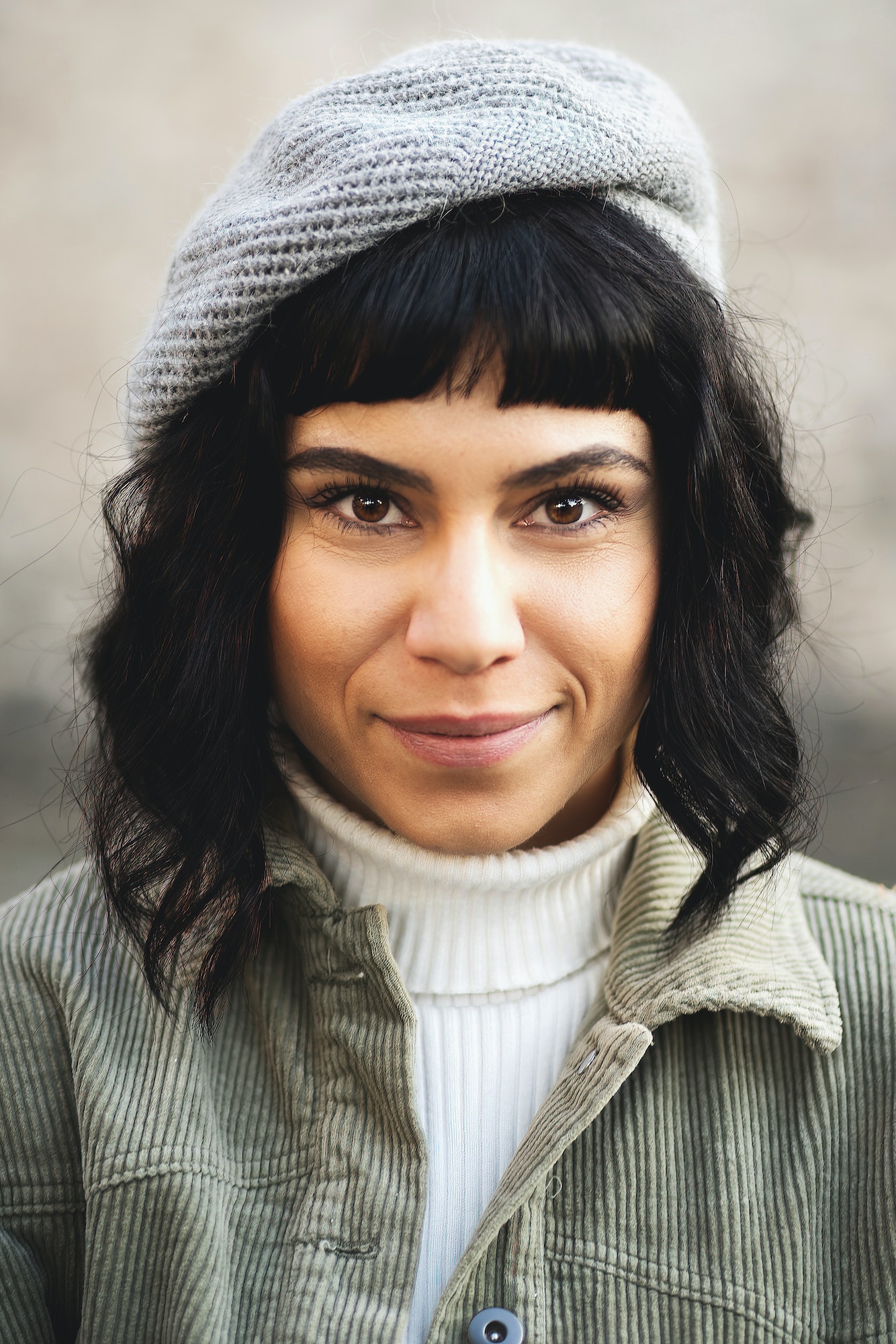 Head shot portrait of a European brunette wearing hat